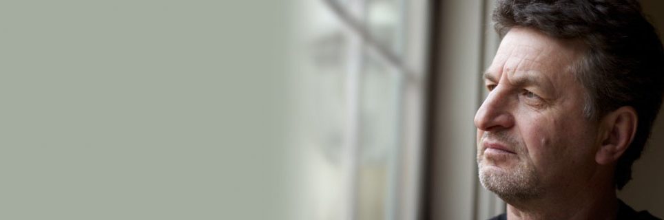 man looking out window